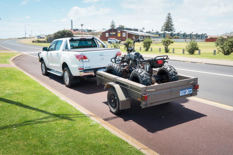 car towing trailer on motorway limit